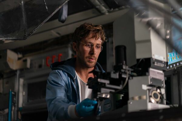 A man sits in a lab using scientific equipment