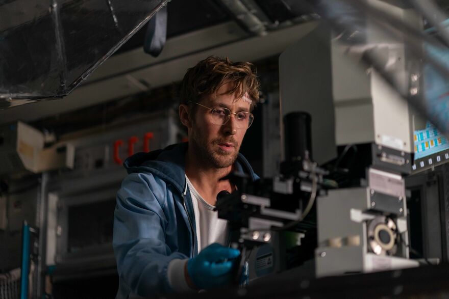 A man sits in a lab using scientific equipment