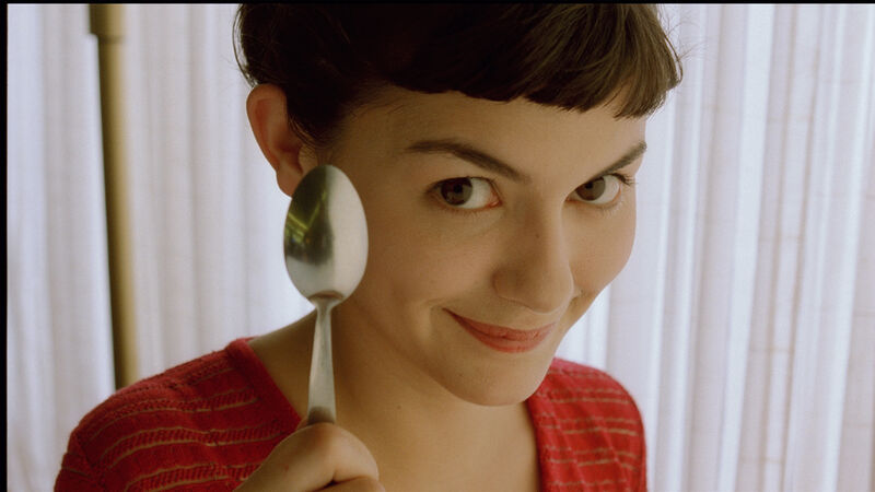 Amelie smiles, and holds a teaspoon