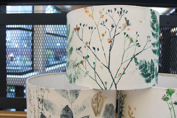 Lampshades printed with flower and leaf designs with gold leaf details