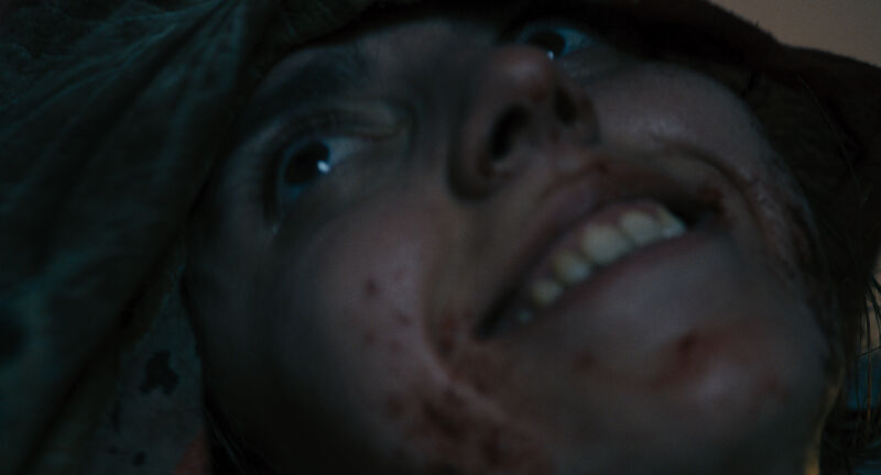 Close up of persons face as the smile eerily 