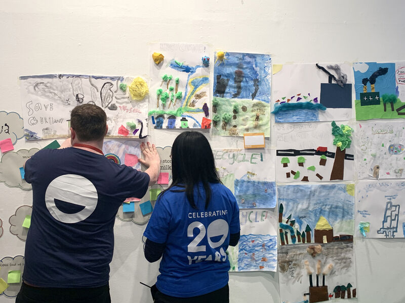 Discovery staff adding children's posters to the wall