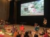 Children watching a film and playing instruments