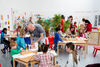 Gallery 1 full of families doing creative activities at different tables as part of Spring Holiday Pop Up