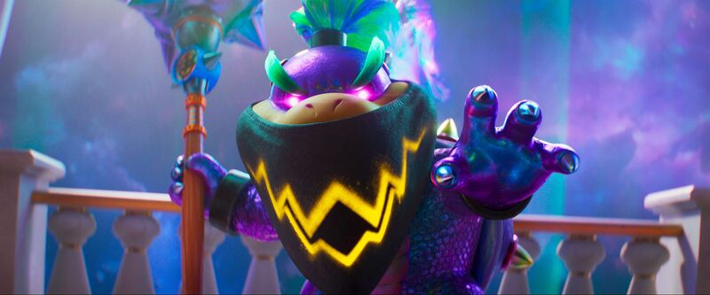 A still from the animated film The Super Mario Galaxy Movie shows Bowser Junior wearing a mask and holding a staff