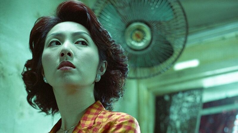 Woman with dark hair standing in front of a fan
