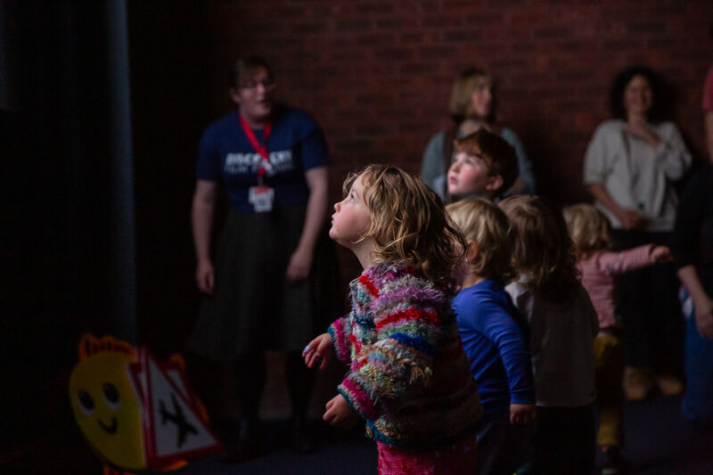 Children standing in front of the cinema screen