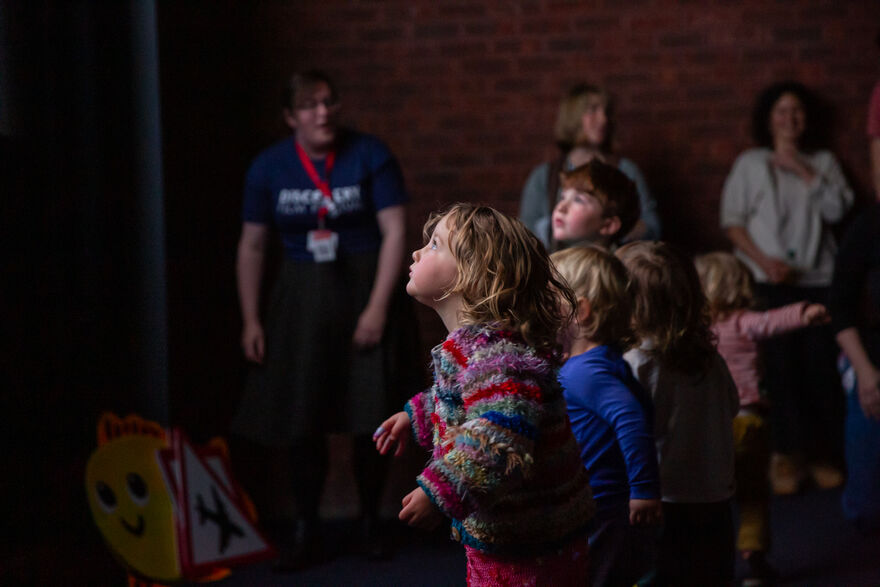 Children standing in front of the cinema screen