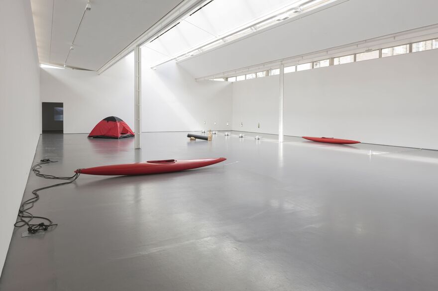 DCA Gallerie during Roman Signer's exhibition. A red kayak can be seen in the middle of the room, along with a red tent.