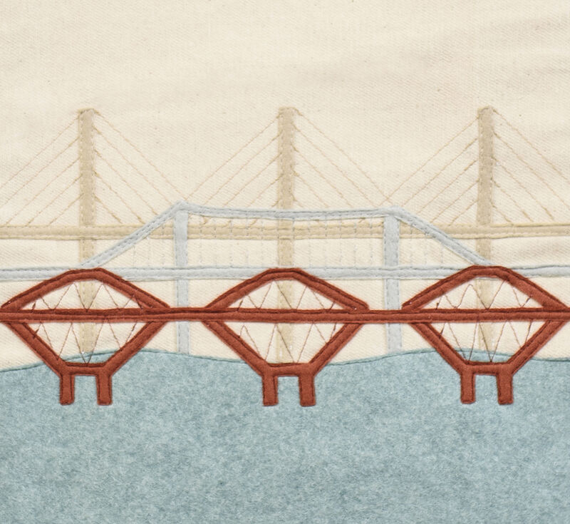 Close up of fabric handging with view of three bridges across the Forth