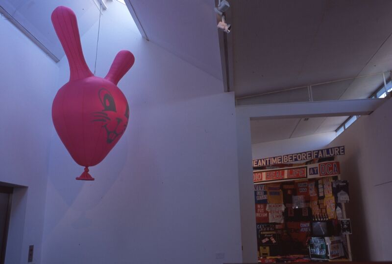 A pink balloon with ears like a cartoon rabbit.