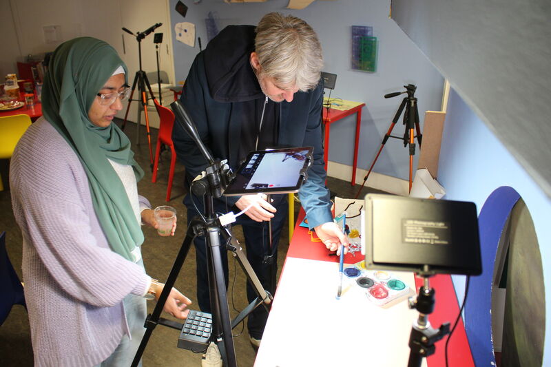 Tutor and participant painting to create an animation