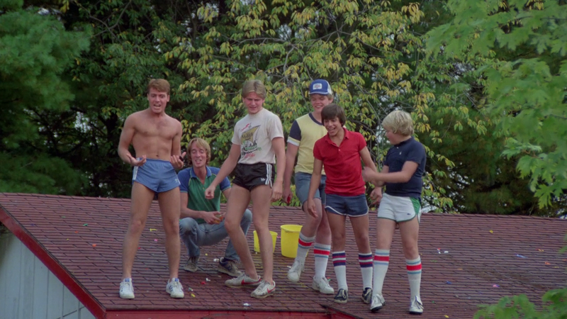 Group of teenage boys standing on a roof