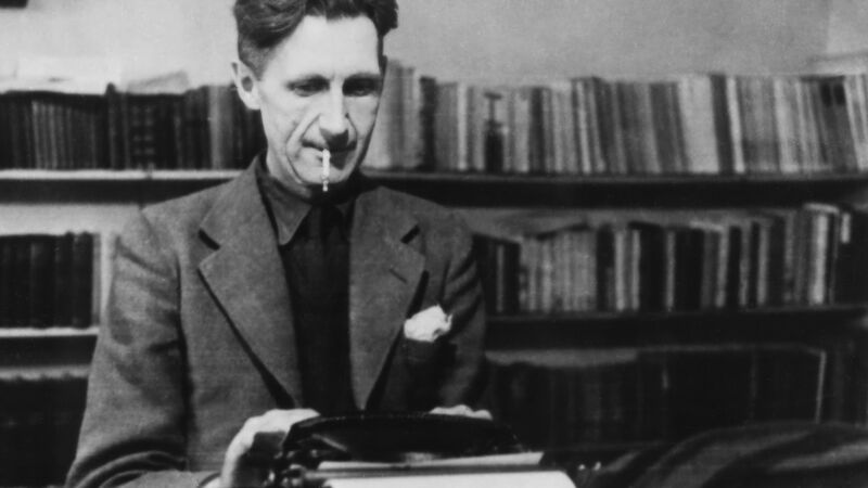 Author George Orwell sitting at a typewriter