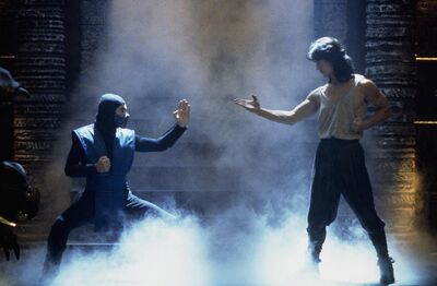 Two men in fighting poses surrounded by smoke