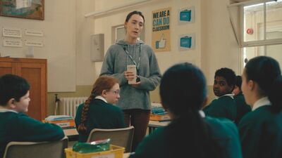 A teacher sounds in her classroom looking exasperated at a group of pupils