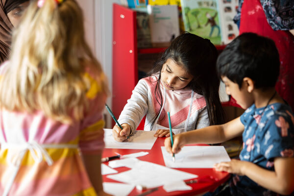 Children drawing at a table in Create Space