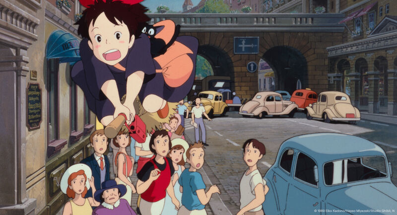 A young girl and a cat fly over a crowded street on a broomstick