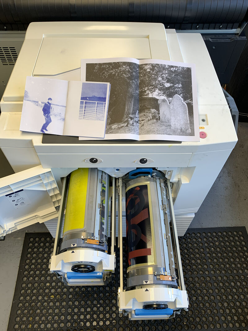 Rsio machine with ink drums open and zine prints on top