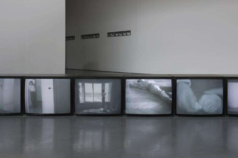 From the Ellipsis exhibition. A row of 14 televisions each display blurry black-and-white images.