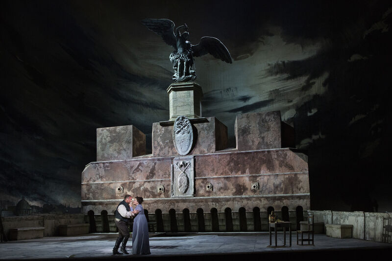 A man and woman embrace in Tosca