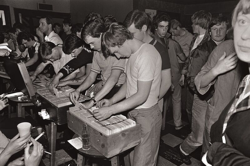 Vintage stil of young men looking at vinyl records.