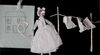 Animation still shows a paper doll in a napkin dress with a washing line.