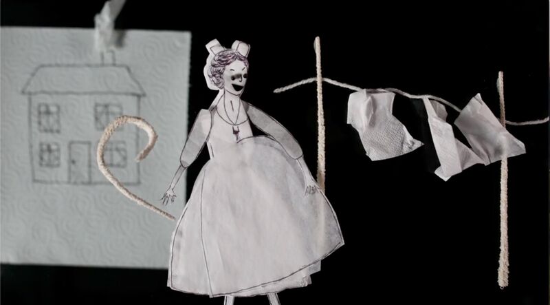 Animation still shows a paper doll in a napkin dress with a washing line.