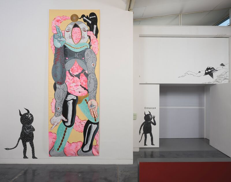A large mural from Hideyuki Katsumata shows a surreal and colourful painting of a man. There is a black figure with horns looking up at the figure.