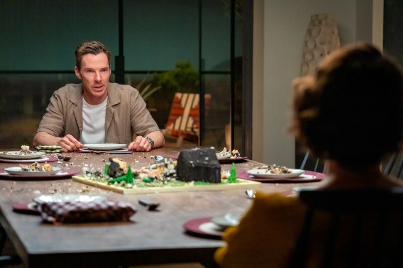 A man faces his wife over a dinner table.