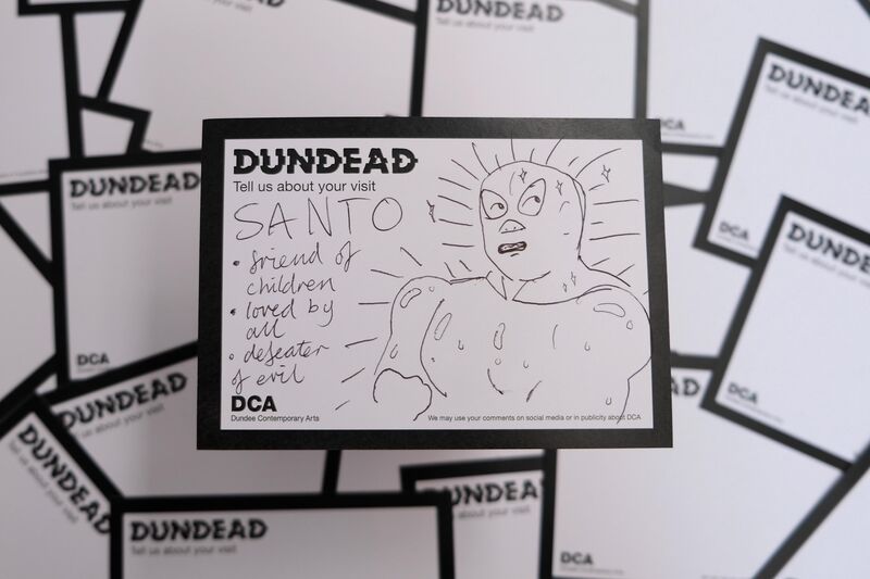 Dundead comment card with drawing of wrestler and text: Santo - friend of children - loved by all - defeater of evil