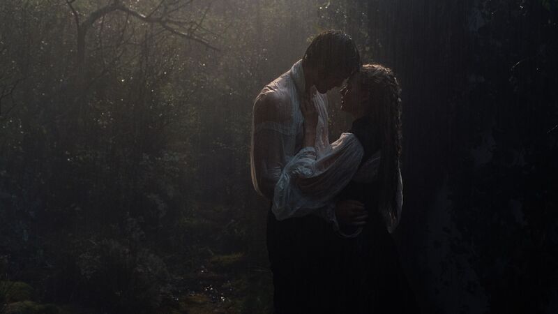 A man and a woman hold each other in the rain