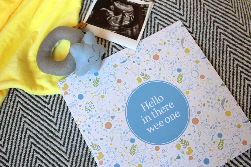 Hello in there wee one book surrounded by baby scan and tys