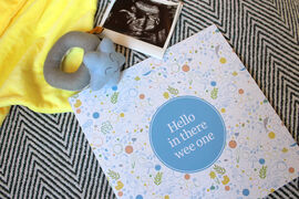 Hello in there wee one book surrounded by baby scan and tys