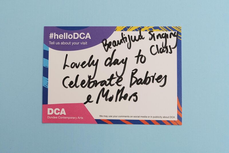 Handwritten feedback card: 'Beautiful singing class. Lovely day to celebrate babies and mothers'
