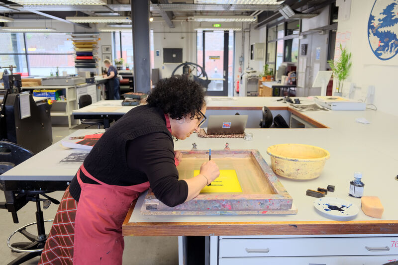 Zineb Sedira painting onto a silk screen