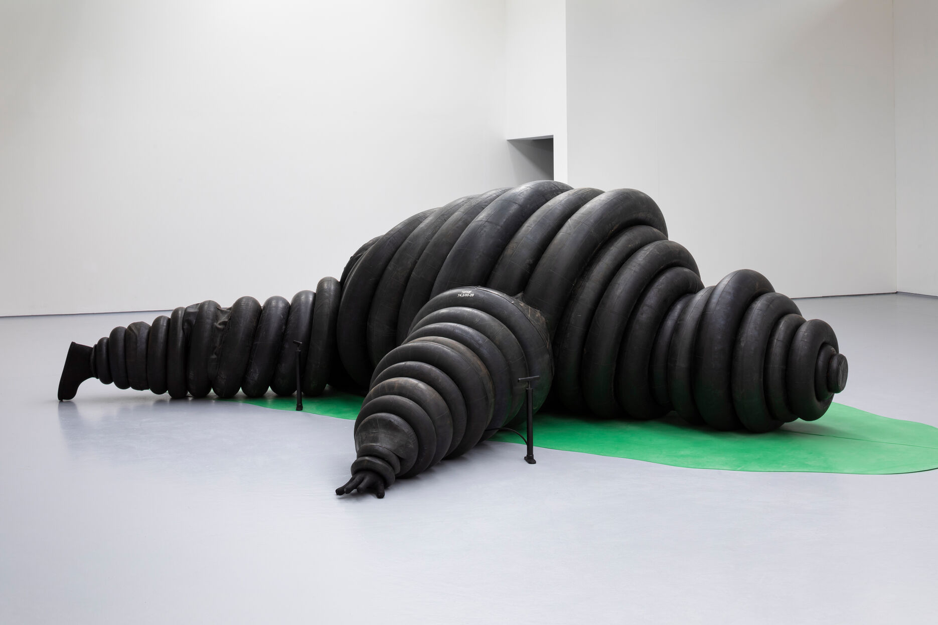 A large Michelin man sculpture on a banana leaf 