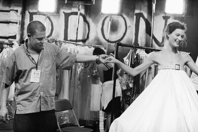 Alexander McQueen holds the hand of a model ahead of a fashion show