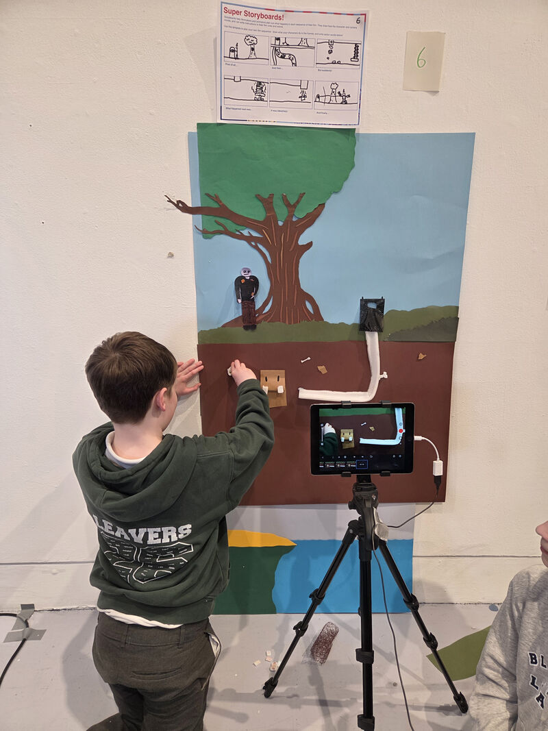 Pupil making a stop motion animation using a paper set