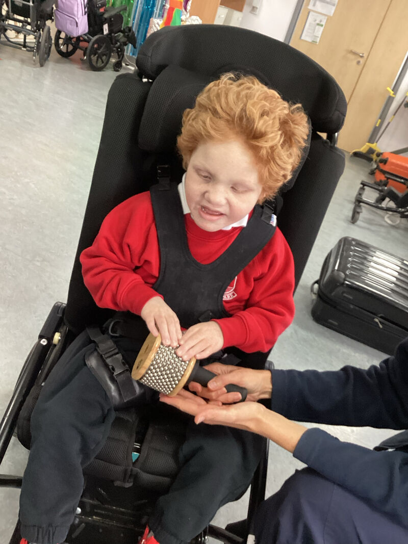 Child testing a musical instrument