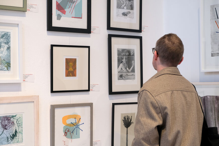 Person looking at framed prints